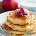 A delicious plate of Farmers Cheese Pancakes with Apple (Syrniki)
