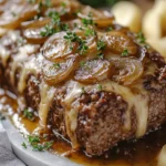 A delicious plate of French Onion Meatloaf with Melted Swiss Cheese – Slow Cooker Style 🥘🧀