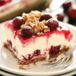 A delicious plate of Layered Cherry Cheesecake Lush Dessert Recipe