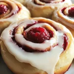 A delicious plate of Raspberry Cinnamon Rolls with Lemon Glaze