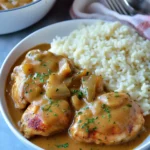 A delicious plate of Smothered Chicken with Peppers & Onion Gravy